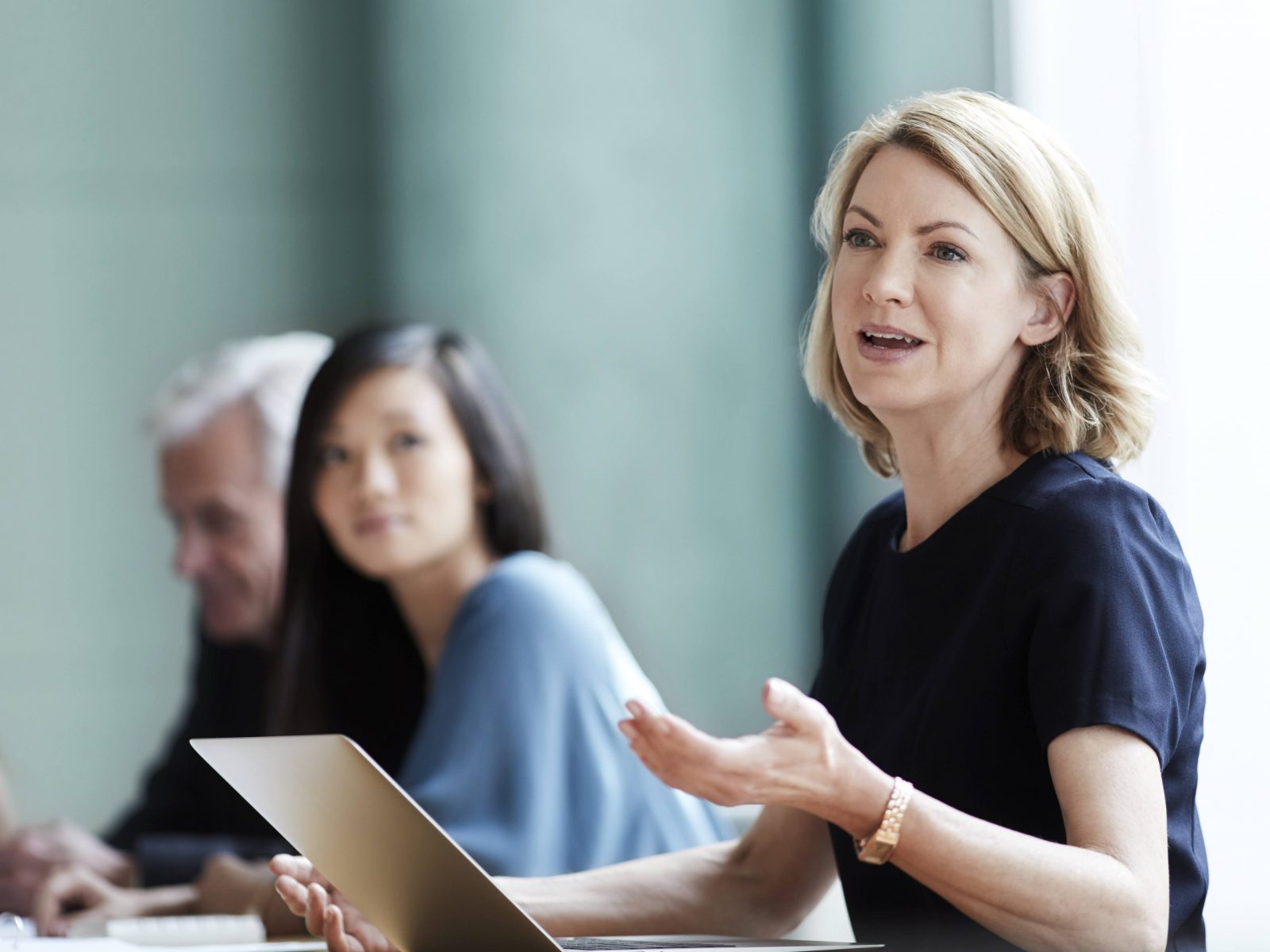 Woman presenting to colleagues in meeting