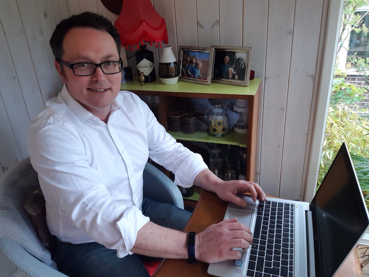 Mark Tock sitting in front of his laptop in his working from home environment